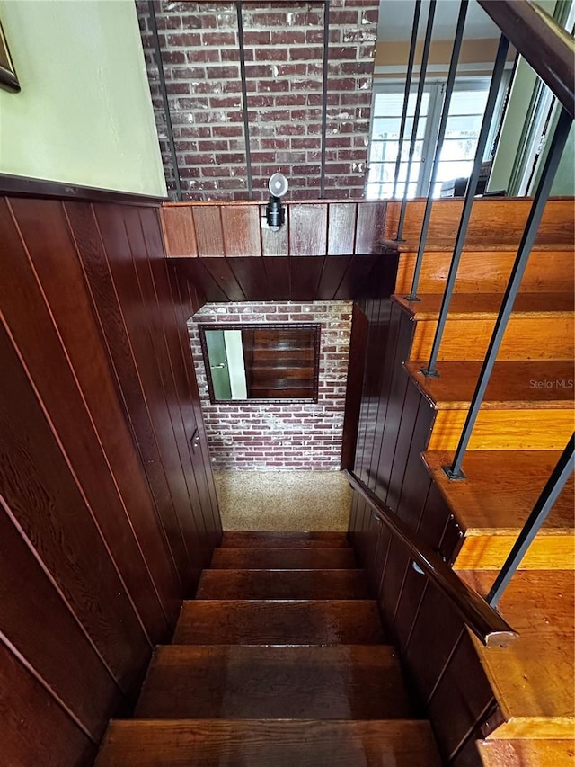 stairs featuring wooden walls