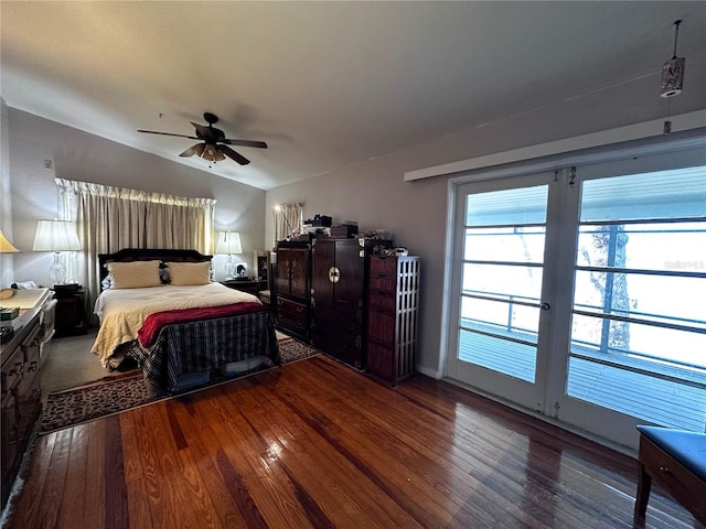 bedroom with lofted ceiling, hardwood / wood-style floors, and a ceiling fan