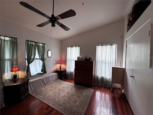 bedroom with a ceiling fan, lofted ceiling, and hardwood / wood-style flooring