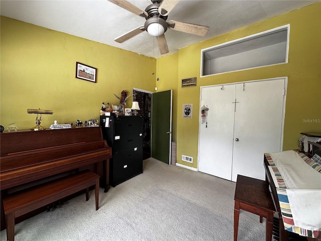 sitting room with carpet flooring and a ceiling fan