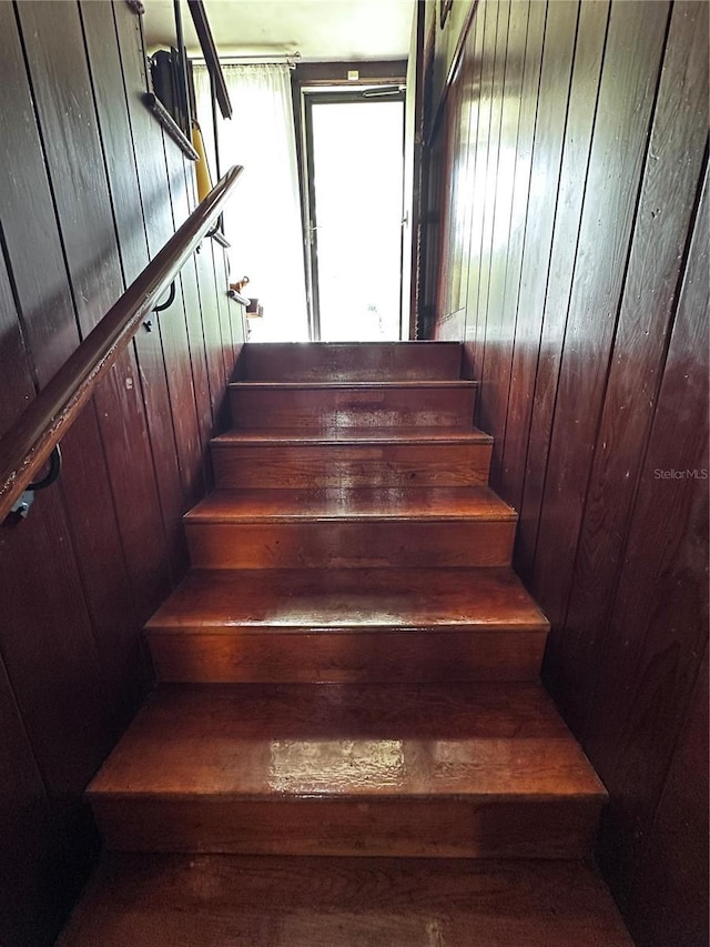 stairs with wood walls