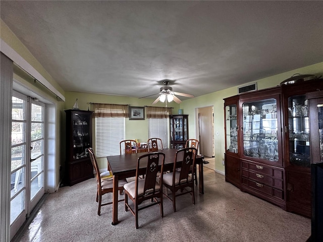 dining space with light colored carpet, a ceiling fan, visible vents, and baseboards