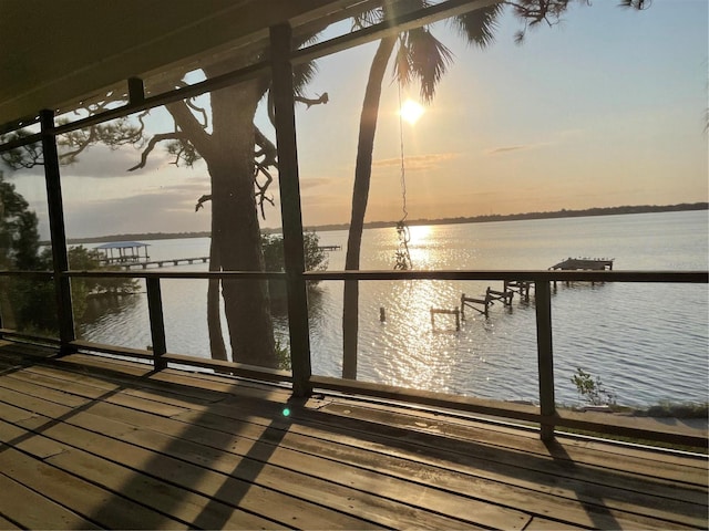 view of dock with a water view and a balcony