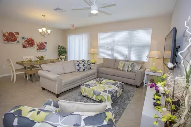 living room with ceiling fan with notable chandelier and visible vents