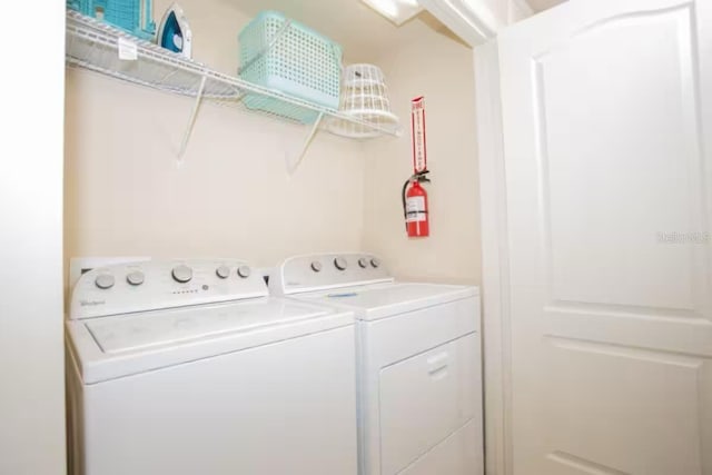 laundry room featuring washing machine and clothes dryer