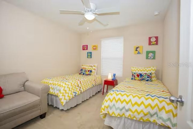 bedroom featuring light colored carpet and a ceiling fan