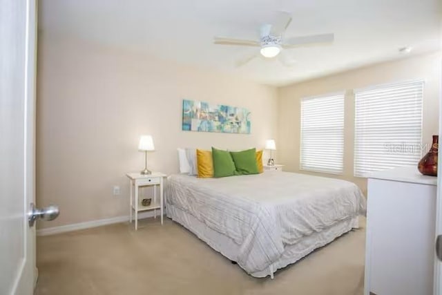 bedroom with a ceiling fan and baseboards