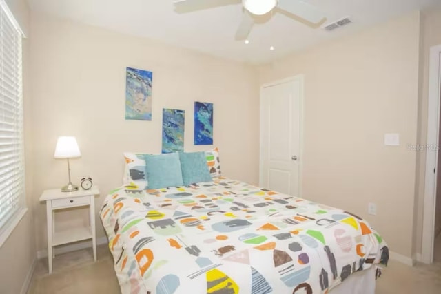 bedroom with visible vents, baseboards, and a ceiling fan