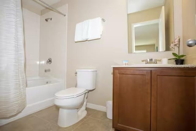 full bathroom with vanity, baseboards, tile patterned flooring, shower / tub combo, and toilet