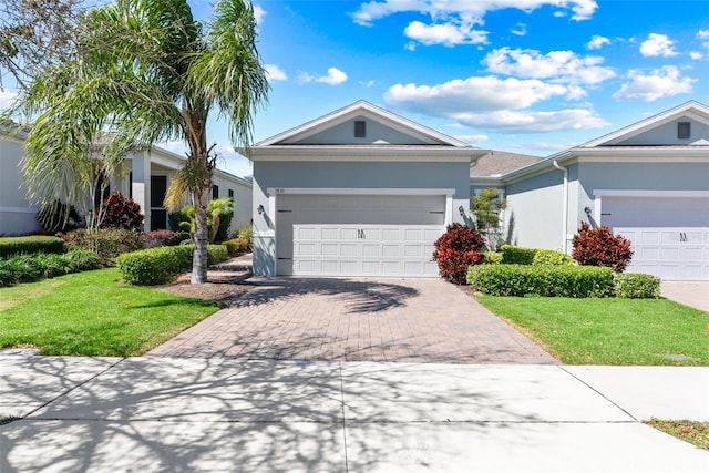 ranch-style house with stucco siding, driveway, a front yard, and a garage