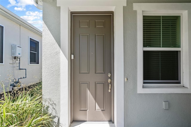 entrance to property with stucco siding