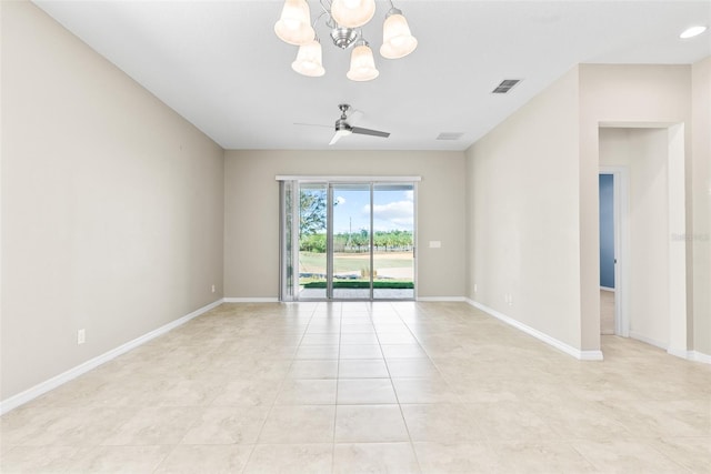 empty room with visible vents, light tile patterned flooring, ceiling fan with notable chandelier, and baseboards