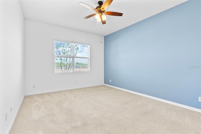 spare room featuring carpet flooring, a ceiling fan, and baseboards