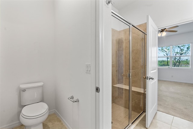 full bath with a shower stall, baseboards, toilet, tile patterned floors, and a ceiling fan