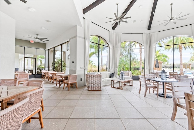 sunroom / solarium with beamed ceiling and ceiling fan