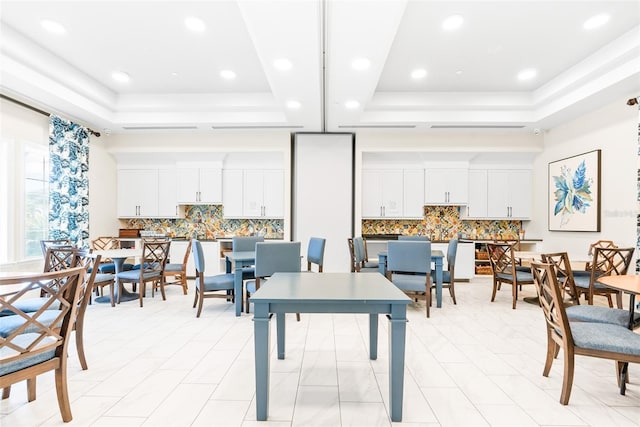 dining space featuring a raised ceiling and recessed lighting