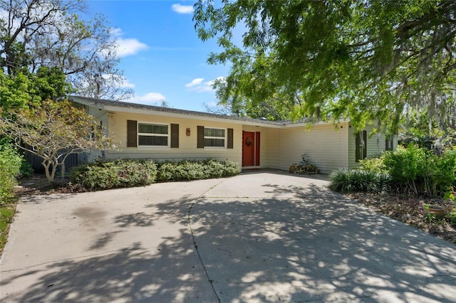 ranch-style home with concrete driveway