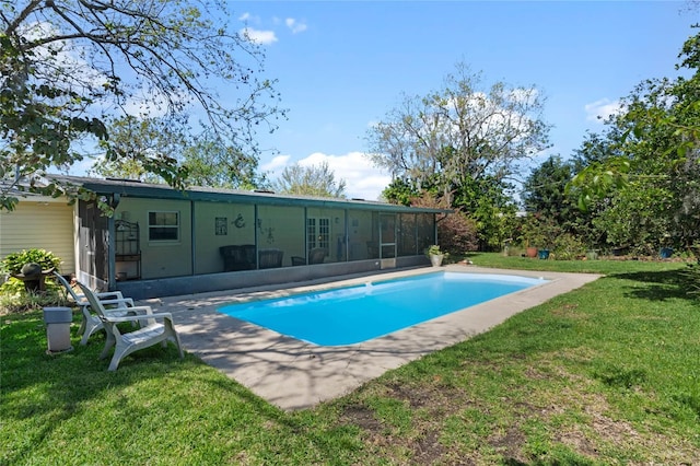 pool featuring a lawn and a sunroom