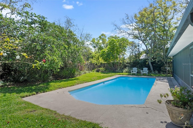 view of swimming pool with a yard, a fenced in pool, a fenced backyard, and a patio area