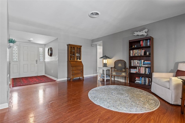 sitting room with visible vents, baseboards, and wood finished floors