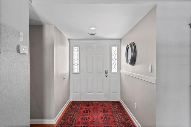 entrance foyer with visible vents and baseboards