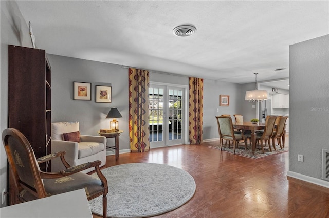 sitting room featuring visible vents, baseboards, and french doors