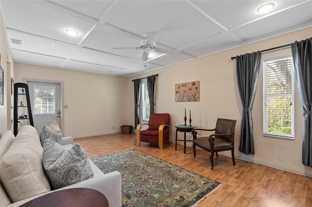 living area with baseboards, visible vents, coffered ceiling, ceiling fan, and light wood-type flooring