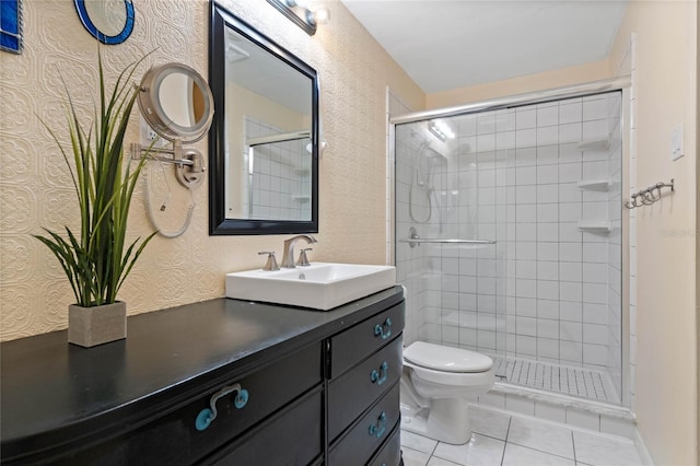 bathroom featuring tile patterned floors, toilet, a stall shower, and vanity