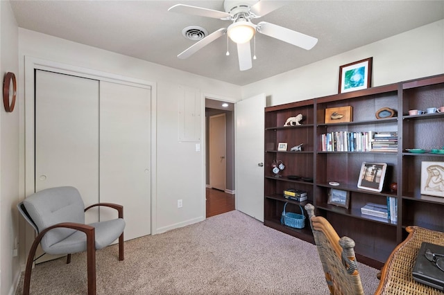 office space featuring visible vents, carpet floors, and ceiling fan