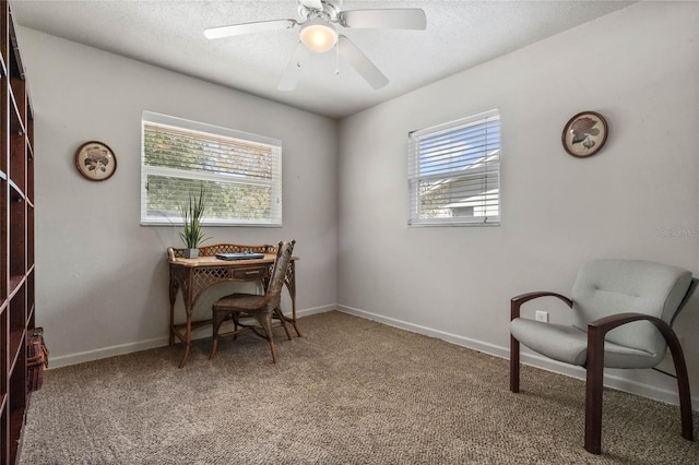 office with a textured ceiling, ceiling fan, baseboards, and light carpet