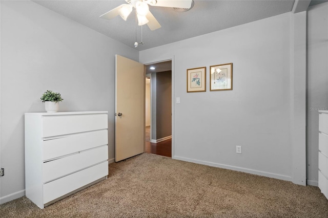 unfurnished bedroom with baseboards, carpet floors, and ceiling fan