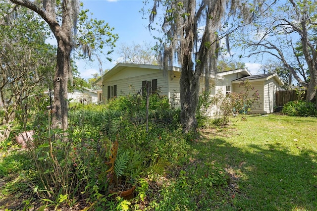 exterior space with a lawn and fence