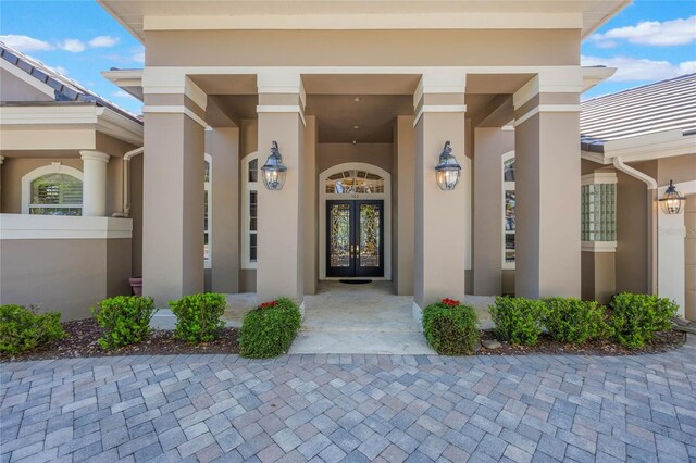 doorway to property with french doors and stucco siding