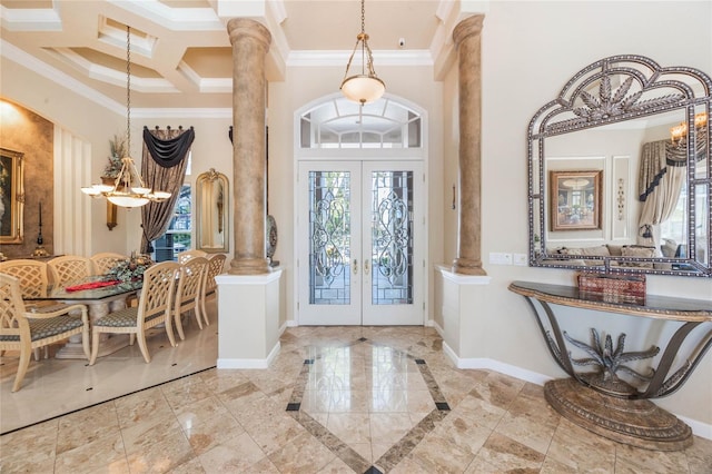 foyer entrance featuring decorative columns, baseboards, crown molding, and french doors