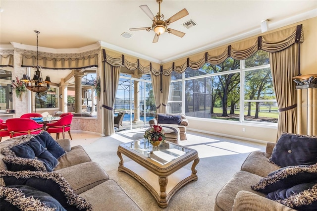 sunroom / solarium featuring a wealth of natural light, visible vents, a ceiling fan, and decorative columns