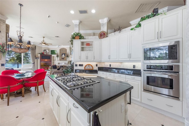 kitchen featuring stainless steel appliances, dark countertops, visible vents, and white cabinets