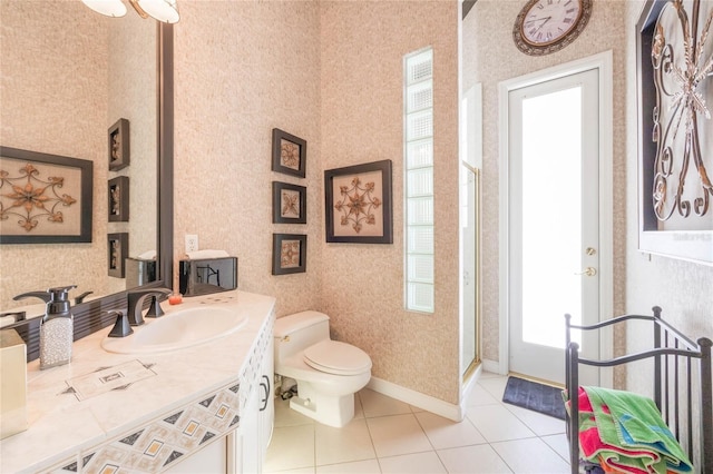 bathroom with toilet, tile patterned flooring, wallpapered walls, baseboards, and vanity