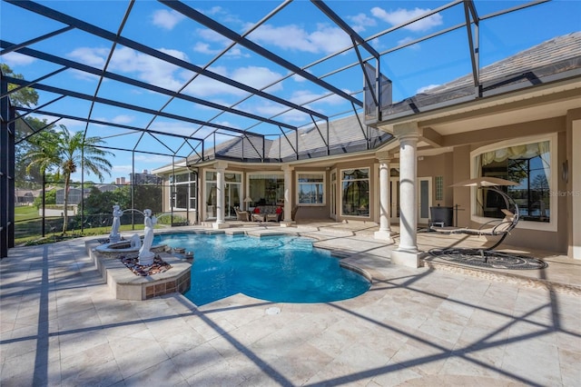 pool with glass enclosure and a patio area