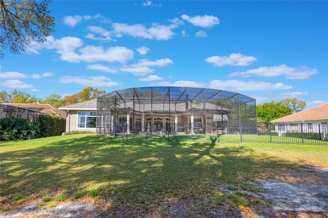 back of property featuring glass enclosure, a yard, fence, and stucco siding