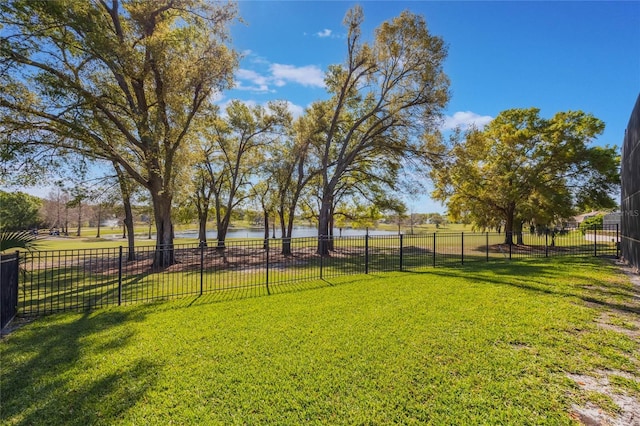 view of yard featuring a water view and fence