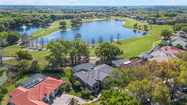 drone / aerial view featuring golf course view and a water view