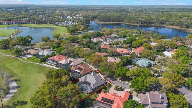 aerial view with golf course view, a water view, and a residential view