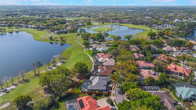 birds eye view of property with a residential view, a water view, and view of golf course