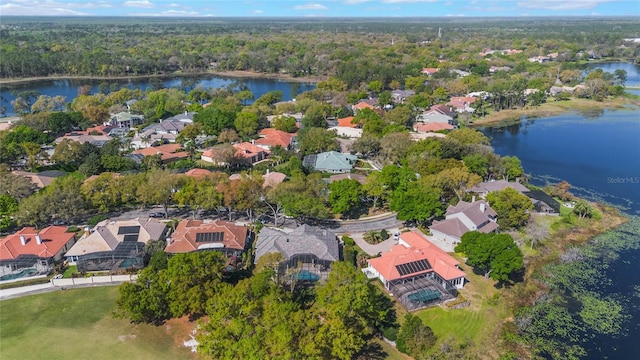 bird's eye view with a residential view, a view of trees, and a water view