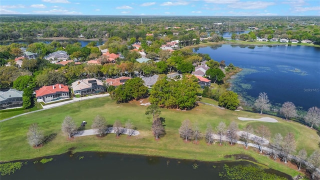 aerial view with golf course view and a water view