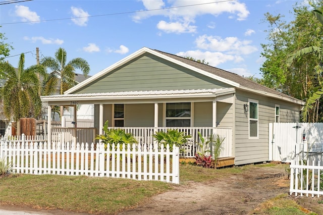 view of front of property with a fenced front yard and a porch