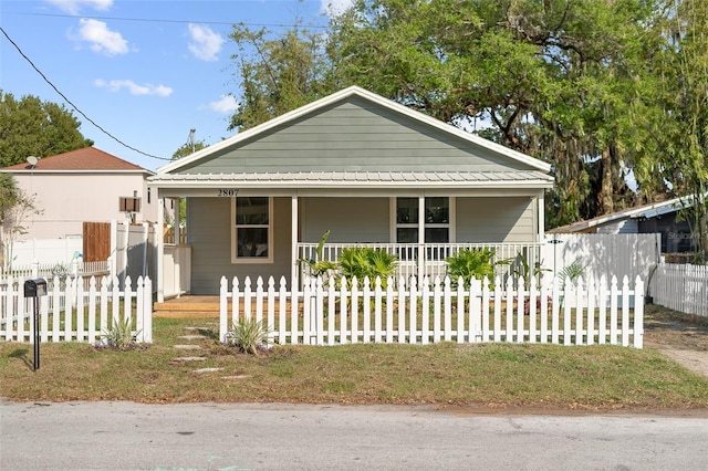 view of front of property with a porch and a fenced front yard