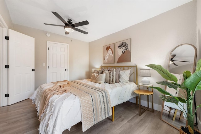 bedroom featuring wood finished floors and a ceiling fan