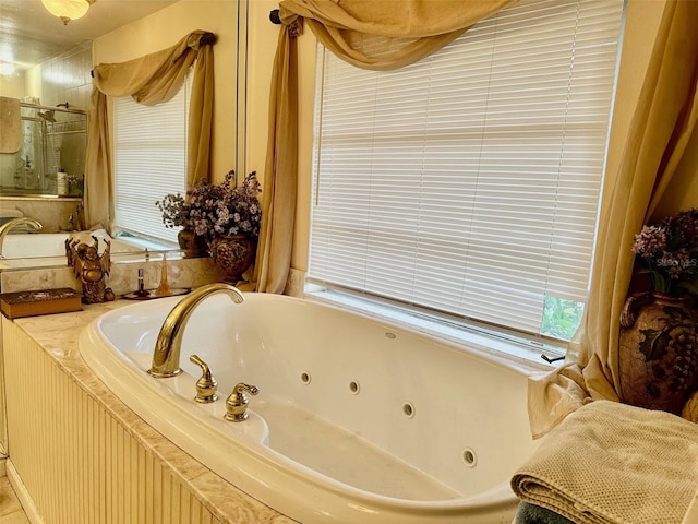 full bath featuring a stall shower and a whirlpool tub