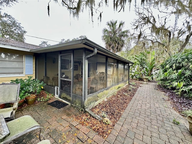 view of property exterior featuring a sunroom